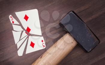 Hammer with a broken card, vintage look, three of diamonds