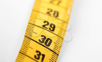Measuring tape isolated on white, selective focus on 30
