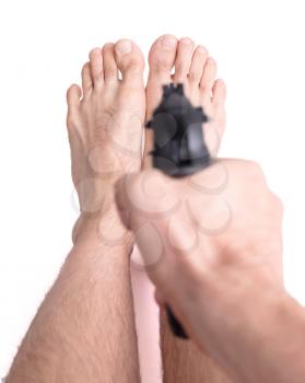 Concept - Man shooting himself in the foot