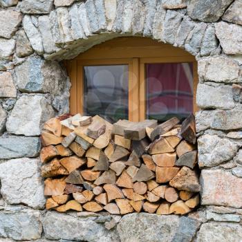 Firewood logpile stacked in a window - Austria