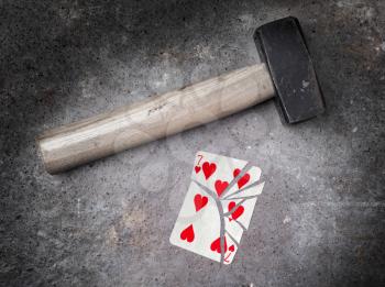 Hammer with a broken card, vintage look, seven of hearts
