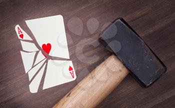 Hammer with a broken card, vintage look, ace of hearts
