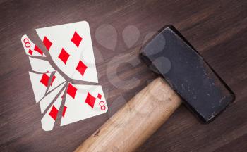 Hammer with a broken card, vintage look, eight of diamonds