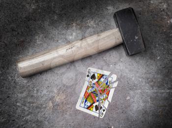 Hammer with a broken card, vintage look, queen of spades