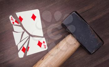 Hammer with a broken card, vintage look, four of diamonds