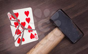 Hammer with a broken card, vintage look, nine of hearts