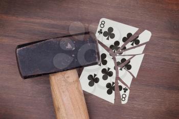 Hammer with a broken card, vintage look, eight of clubs