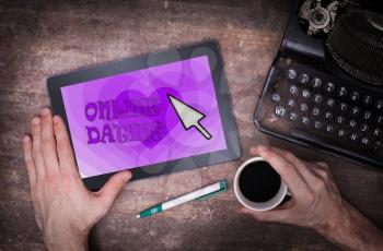 Online dating on a tablet - concept of love, purple