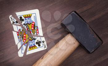 Hammer with a broken card, vintage look, king of clubs