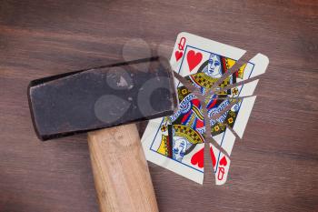 Hammer with a broken card, vintage look, queen of hearts
