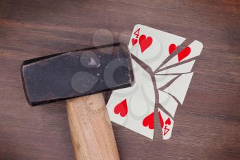 Hammer with a broken card, vintage look, four of hearts