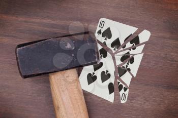 Hammer with a broken card, vintage look, ten of spades