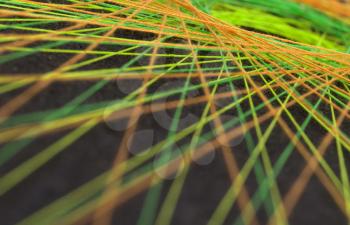 Display of colorful threads on a black panel