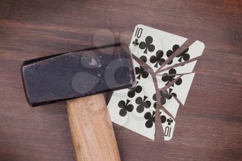Hammer with a broken card, vintage look, ten of clubs