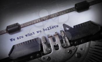 Vintage inscription made by old typewriter, We are what we believe