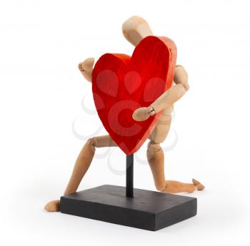 Wooden mannequin with a big heart - isolated on white background