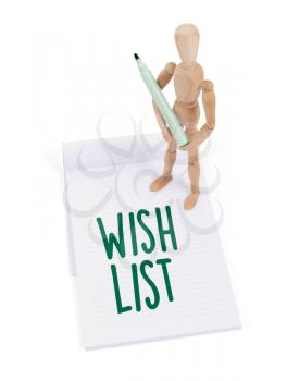 Wooden mannequin writing in a scrapbook - Wish list