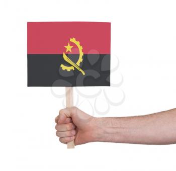 Hand holding small card, isolated on white - Flag of Angola