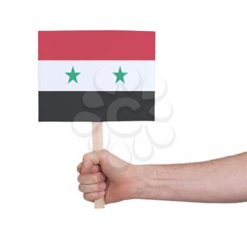 Hand holding small card, isolated on white - Flag of Syria