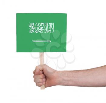 Hand holding small card, isolated on white - Flag of Saudi Arabia