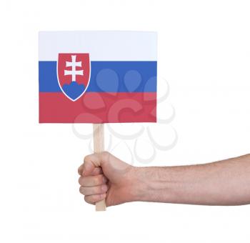 Hand holding small card, isolated on white - Flag of Slovakia