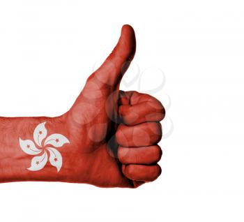 Closeup of male hand showing thumbs up sign, flag of Hong Kong