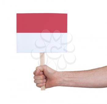 Hand holding small card, isolated on white - Flag of Monaco