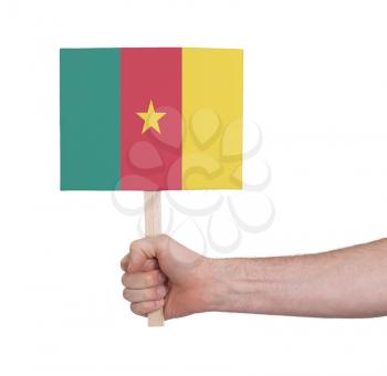 Hand holding small card, isolated on white - Flag of Cameroon