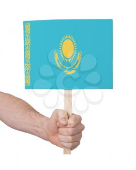 Hand holding small card, isolated on white - Flag of Kazakhstan