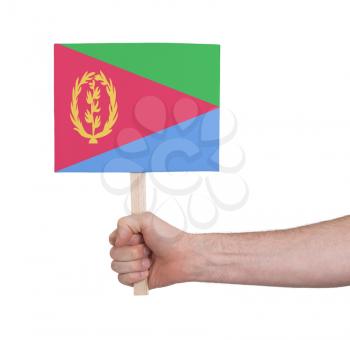 Hand holding small card, isolated on white - Flag of Eritrea