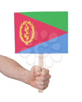 Hand holding small card, isolated on white - Flag of Eritrea