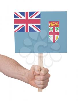 Hand holding small card, isolated on white - Flag of Fiji