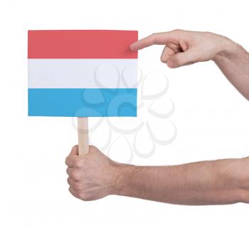 Hand holding small card, isolated on white - Flag of Luxembourg