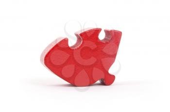 Closeup of big red jigsaw puzzle piece isolated on white