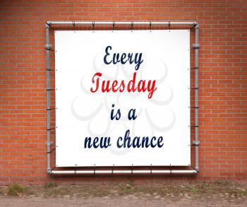 Large banner with inspirational quote on a brick wall - Every tuesday is a new chance