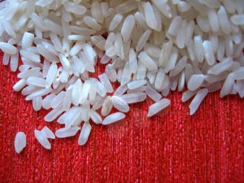 Handful of rice scattered on a red background