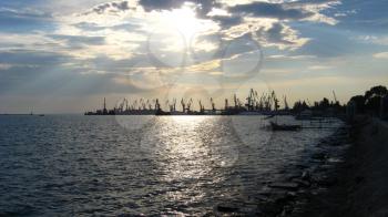 panorama of the evening sea with docks and hoisting crane