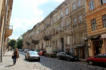 narrow street in Lvov with parked cars in the central part of Lvov