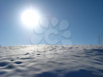 Winter solar landscape with bright snow on the sun