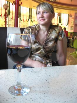 the girl with glass of red wine in restaurant