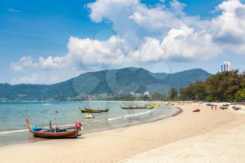Traditional long tail boat on Patong beach and Andaman sea on Phuket in Thailand in a summer day