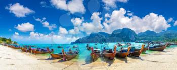Panorama of Traditional thai longtail boat at Log Dalum Beach on Phi Phi Don island, Thailand in a summer day