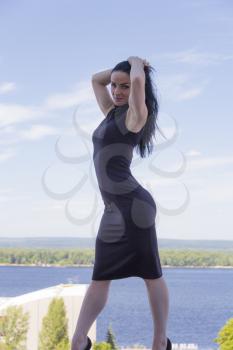 Standing Caucasian woman with upward hands on river background