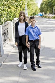 Brother and sister are walking at summer time