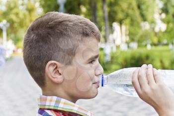 Cute boy are drinking water from bottle