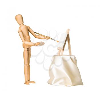 Wooden model dummy painting picture on easel, isolated on white. 