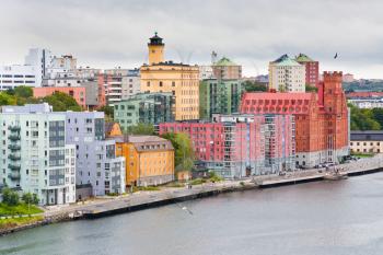 many-colored buildings on waterfront of Saltsjon bay in Stockholm