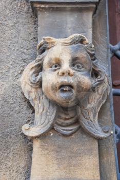 sculpture head on wall of Maison des Tetes in Colmar, France