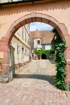 urban yard in medieval Riquewihr town on wine route Alsace. Riquewihr known for the Riesling and other great wines produced in the village