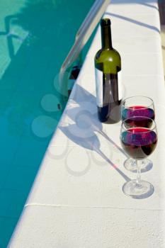 bottle and two glasses with red wine outdoor